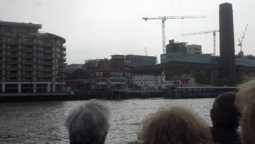 Shakespeare's Globe Theatre is the white round house with the grass/hay roof.