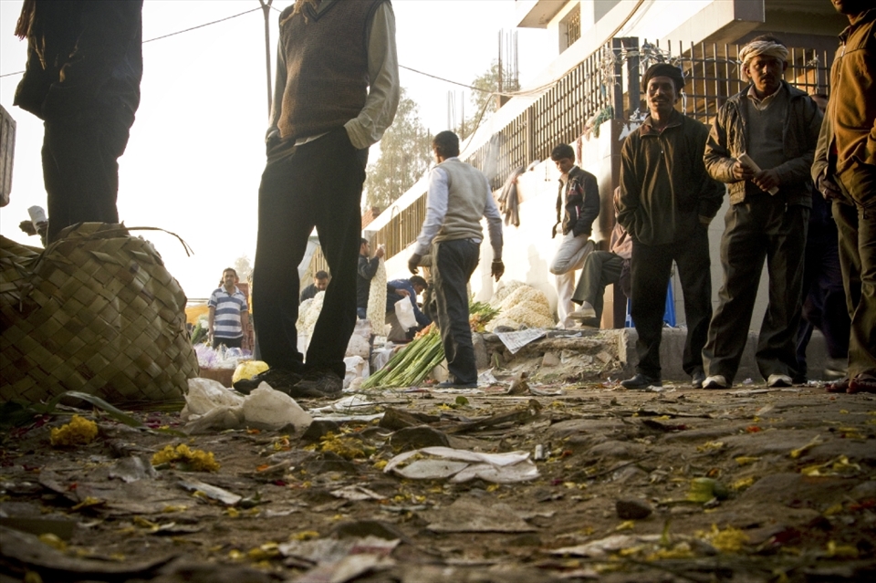 Mud and flower waste are churned by hundreds of stomping feet at the Phool Mandi.