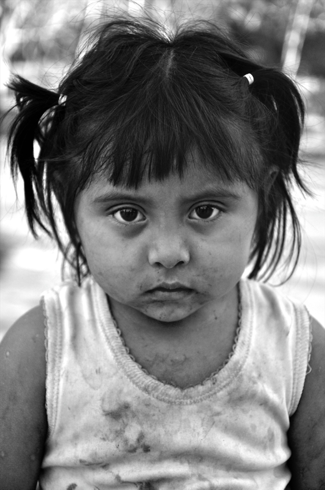 Her name is Ivana. She hardly talks.Sometimes she smiles and she never lets go of her little brother's hand.