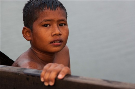 Here one of the boys who had been jumping is taking a breather and waiting for his friends to move out of his jumping space; he’s perched on the outer part of the bridge with his hand resting on the wooden rail.