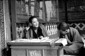 Young monks at Paro Monastery - Two young monks, selling religious amulets and lucky charms, laugh at something my mother asked them. Usually very shy, especially when surrounded by women who point cameras at them, these two couldn't resist after a few minutes of us imploring them to answer a few questions that they thought were absolutely unnecessary or were not difficult enough to be questions. Monk training is very gruelling and requires a great amount of strength. Even the Dalai Lama once admitted he wanted to run away during the course of his monk education. So it is very rare to see them laugh like this, especially the younger ones.: by kavyanjali, Views[1398]