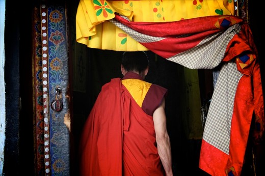 Head monk entering Kyichu Lhakhang - I happened to be inside Kyichu Lhakhang during one of the prayer times and suddenly all around me, from every mouth I could see or not see, from every room of the temple, began a chanting of seven words. The head monk had entered the sanctum sanctorum, and that must have been the cue for everyone to begin their afternoon prayers. Technically without a tune, the chanting, sung loudest by the head monk, turned into something exceptionally powerful and within minutes produced wonderful vibrations, with everyone, including the outsiders who did not know the words at first, singing along, rocking together.