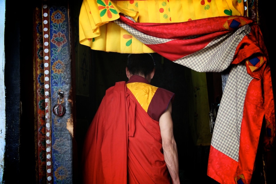 Head monk entering Kyichu Lhakhang - I happened to be inside Kyichu Lhakhang during one of the prayer times and suddenly all around me, from every mouth I could see or not see, from every room of the temple, began a chanting of seven words. The head monk had entered the sanctum sanctorum, and that must have been the cue for everyone to begin their afternoon prayers. Technically without a tune, the chanting, sung loudest by the head monk, turned into something exceptionally powerful and within minutes produced wonderful vibrations, with everyone, including the outsiders who did not know the words at first, singing along, rocking together.