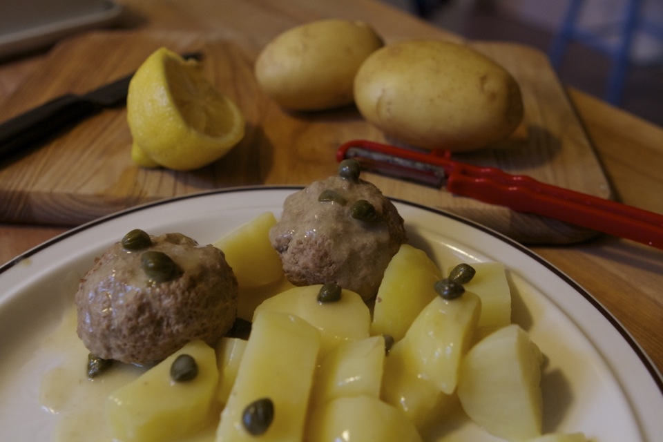 Potatoes and klopse covered in tangy gravy