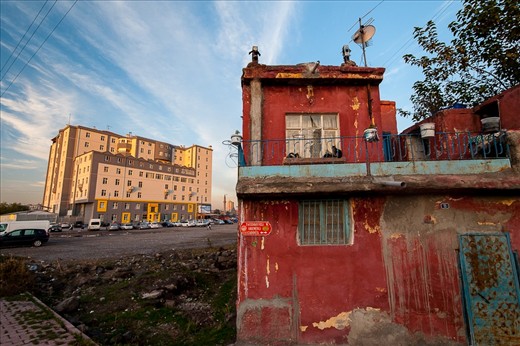 Another shattered house contrasts sharply with the modern building from the area where I was coming from