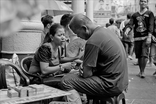 A man listens as his fortune is being told outside Quiapo Church in Manila.