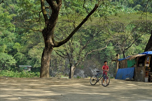 A boy with his bike in Montalban, Rizal, a tourist point for cave explorers.