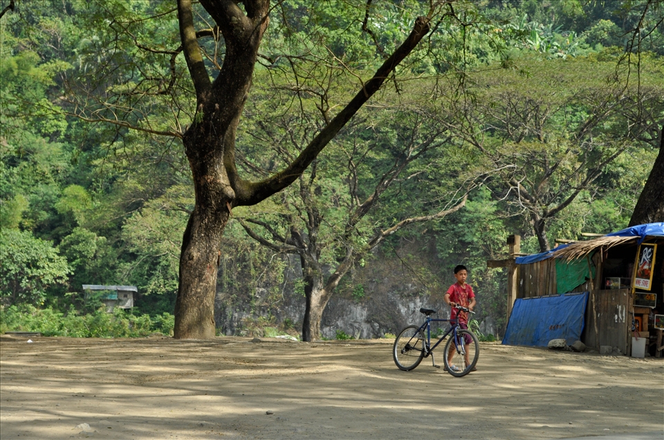 A boy with his bike in Montalban, Rizal, a tourist point for cave explorers.