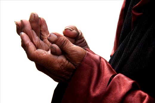 An old Tibet lady was closing her winkled hands and praying sincerely.