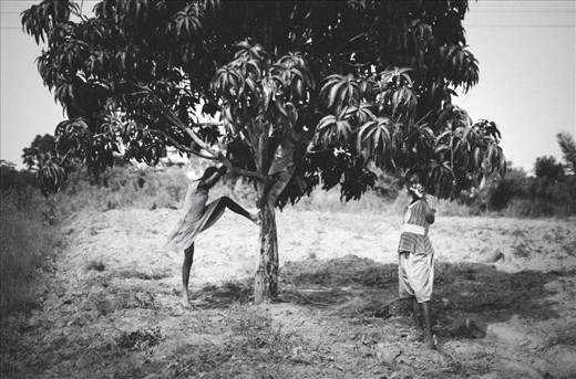 Goswe and her sibling's take a shady break from working on their mother's farm.