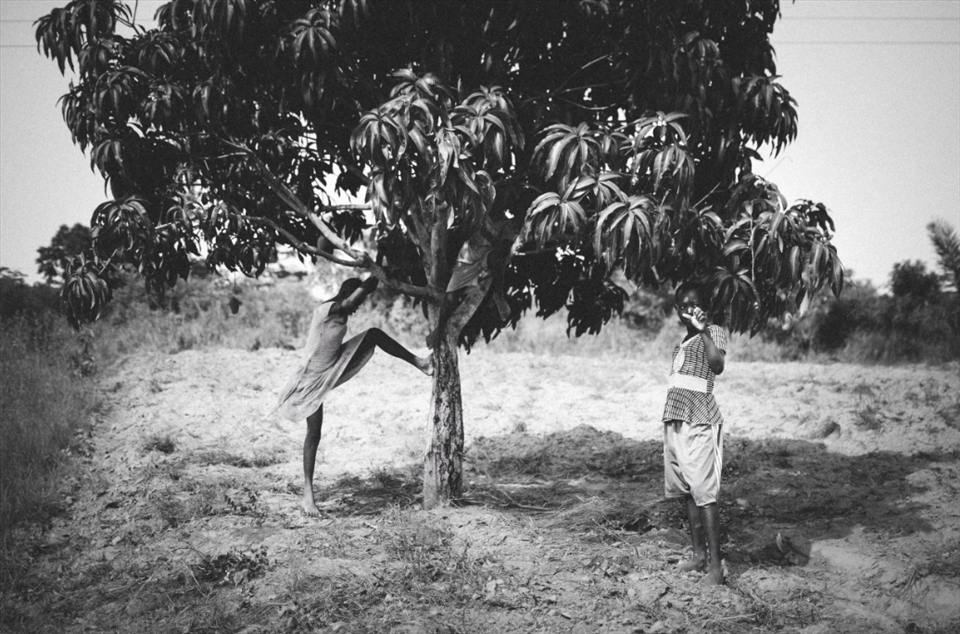 Goswe and her sibling's take a shady break from working on their mother's farm.