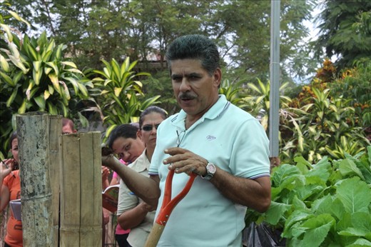 Donald teaching the community how to make a compost pile