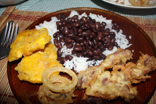 Patacones, fried pescado, onion rings, arroz y frijoles 