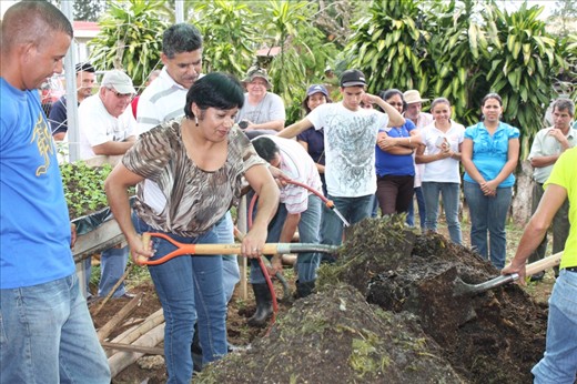 Shoveling the compost into 2 volcanos