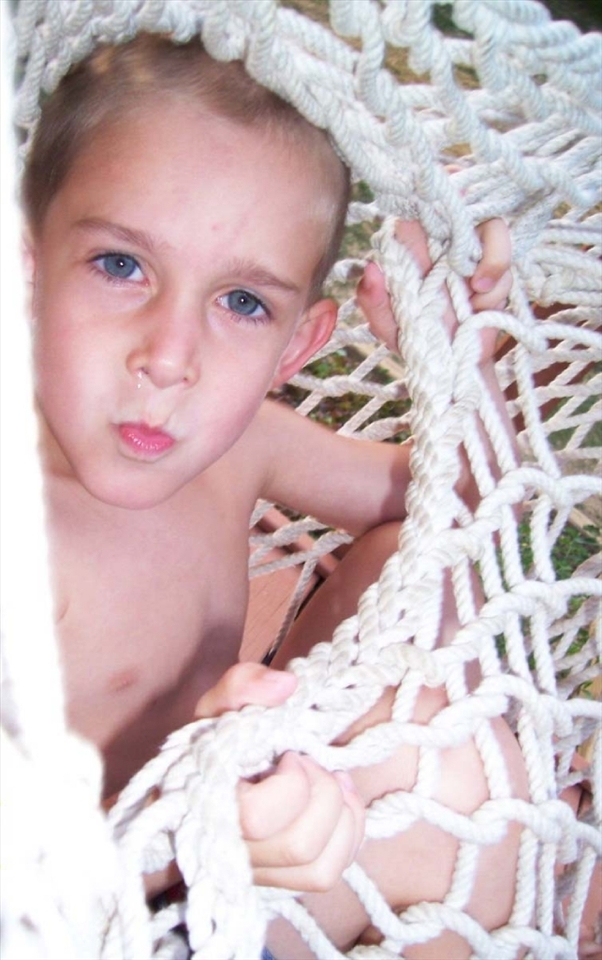 Jacob, the second son (younger than Nicholas) was swinging nonchalantly in the swing up on the deck installed just a week by my host dad. The facial expression changed as per photo when I asked him if I can join him in the swing, apparently not a welcomed question. West Sunbury, Pennsylvania, USA.