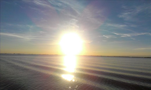 The sea was perfectly still and tired rays of sun formed a great view on it