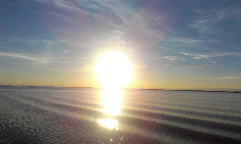 The sea was perfectly still and tired rays of sun formed a great view on it
