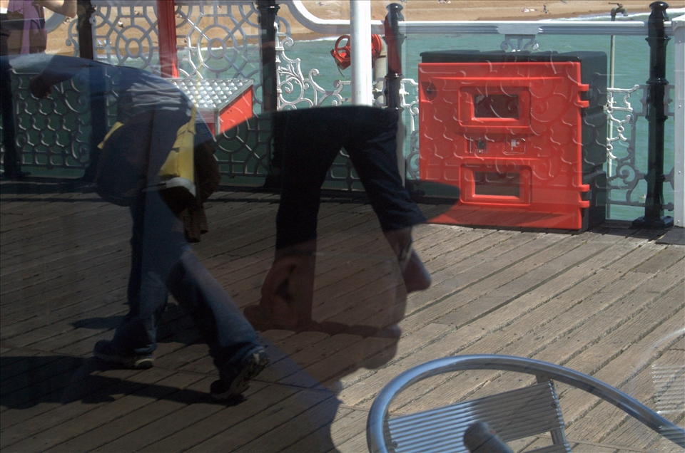 Passage of time is reflected from the ocean and the age of the mans reflection.