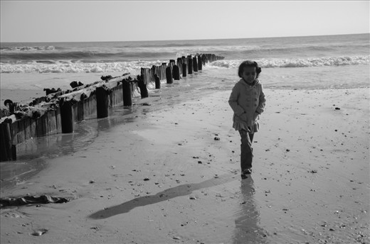 Rockaway Beach, NY: A child walks along the remains of Rockaway Beach. Mustafa Ali, from Brooklyn, called the aftermath a volley of 