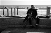 Rockaway Beach, NY: Walking alongside what was left of the boardwalk, I bumped into Tom Ormsby and his protective dog, Roxy. Ormsby lives right by the boardwalk and saw firsthand when the waters rushed in and lifted the boardwalk past his window. When I found him resting by the side of the road with his dog, he was cheerful, but he knew that it would be a while before life in the Rockaways would be restored as he once knew it.. Hurricane Sandy caused an estimated $63 billion USD in damage across the United States on October 2012.: by kevinlizarazo, Views[618]