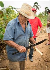 A Cuban farmer smoking a cigar and preparing sugar cane for his guests: by kiddo1981, Views[327]