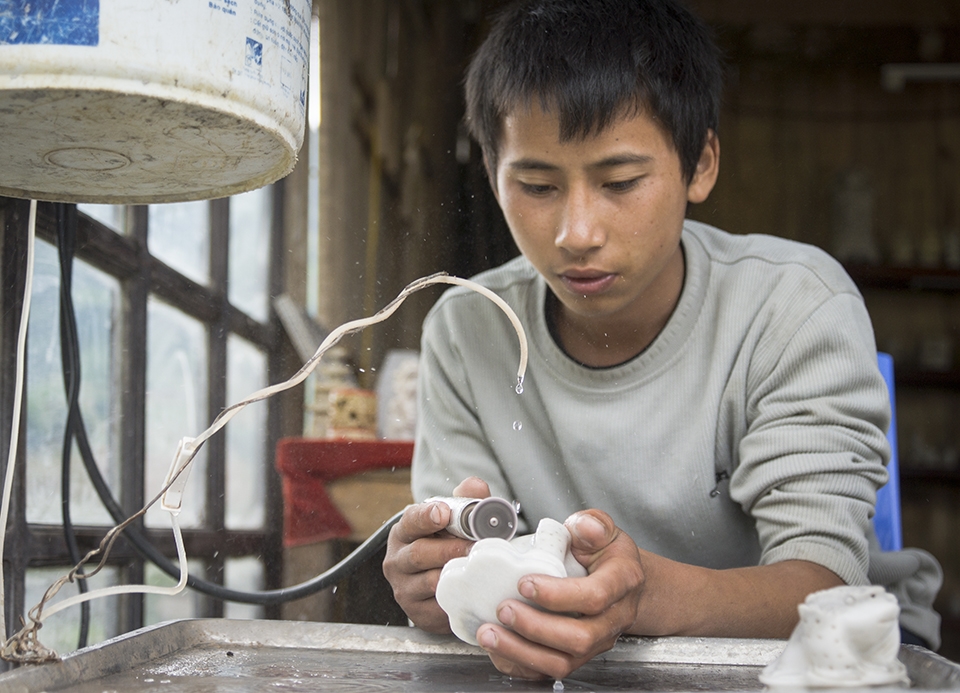 A teenage boy focuses on polishing up his 