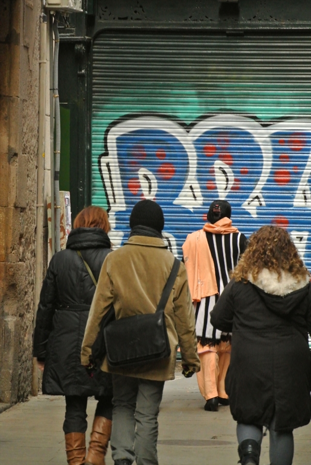 Diversity: An inherently multicultural city, Barcelona combines the Catalan way of life with Spanish influences and an ever increasing influx of foreign tourists. With everyone else rugging up in dull tones to ward off the encroaching winter, this lady pulled out an eye-catching scarf and pants combination to add some colour to her walk through the city.