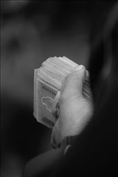 Men crowd around carrying years of savings,  $1400, to make their purchase.: by kipandnoelle1, Views[560]