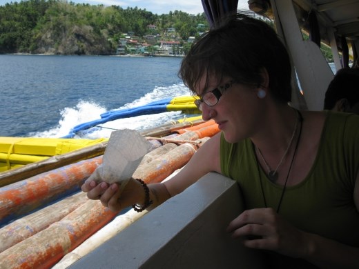 K dropping sea shells back into ocean as we leave