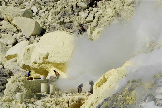 Risking diseases of the lungs, heart and eyes, miners extract pure sulphur as it emerges in molten form from deep within the crater