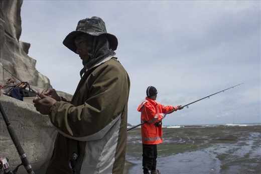 At Murawai beach there is a place fisherman come to test themselves against the elements and ocean. On a long flat rocky outcrop stretching out into the ocean, this is where I met Chit (far right) and his none english speaking friend; both from Myammar, Burma. Chit tells me he and his friend left from Myammar several years ago because as he puts it, 