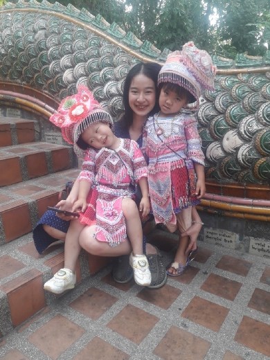 Thai mum with girls in traditional dress