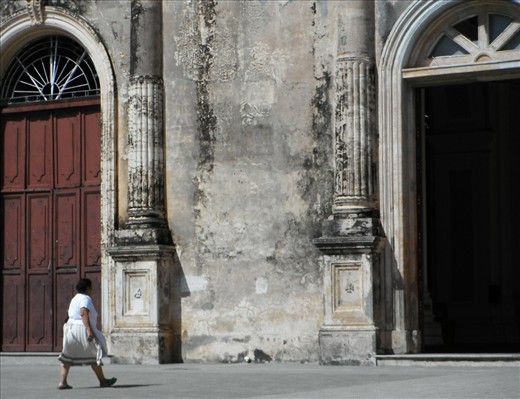 A Nicaraguan woman enters the Iglesia Guadalupe in the old colonial city of Granada. 