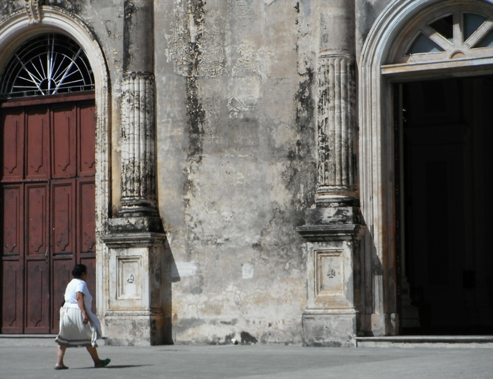 A Nicaraguan woman enters the Iglesia Guadalupe in the old colonial city of Granada. 