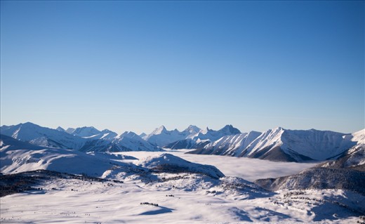 This is one of the ski resorts I'am snowboarding at in the Canadian Rockies it's called Sunshine Village. When it's a sunny day at sunshine ( which only happens twice a year ) all of the clouds are down in the valley and you feel like you are on the top of the world! 

It's such an amazing feeling :D

Tech spec : 
Shutter Speed:1/1250 
Aperture:F/5.0
Focal Length:50 mm
ISO Speed:100
Date Taken:Jan 1, 2013, 10:25:03 AM
Software:Adobe Photoshop Lightroom 4.2 