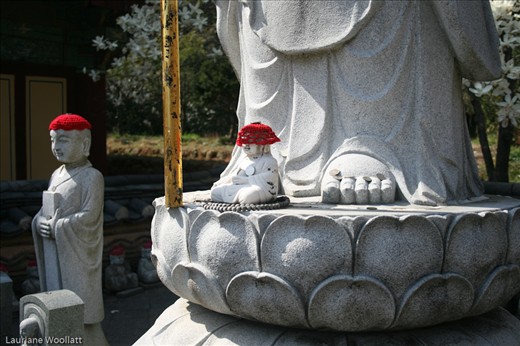 A red-capped statue to preserve the memory of lost babies at Daewon Temple.