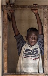 sad eyed African boy inside his father's corner store in Serrekunda, The Gambia: by koyaanisqatsi, Views[627]