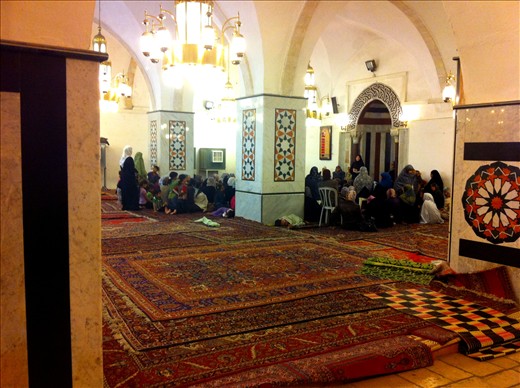 Women and children listen to a passage from the Qu'ran