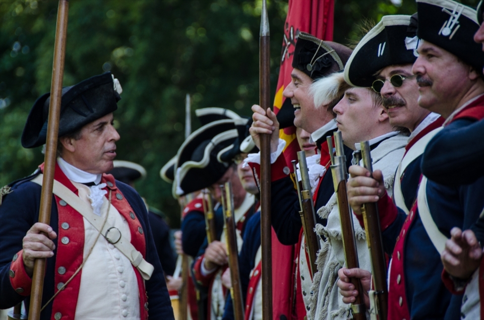 The First Virginia Regiment of the Continental Line, “a Revolutionary War living history reenactment group,” prepares for the military drill on the Bowling Green, the centerpiece of the Independence Day celebration at Mount Vernon. They are wearing layers upon layers of dark wool--insanity in hot and humid Virginia summer--yet seem to enjoy themselves immensely.