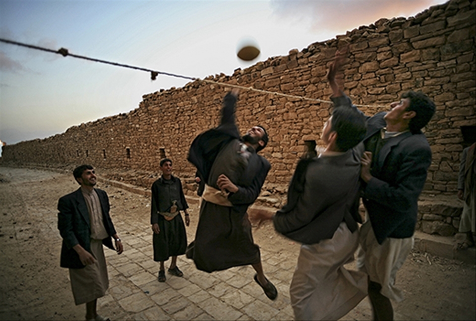 Thula, Yemen: Young boys playing volleyball in the quiet streets of the historic