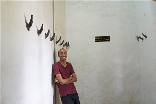 Palace storage room with animal horn hooks and Abe, the guide