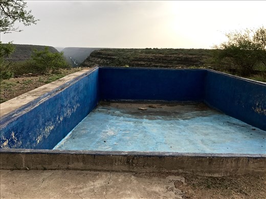 abandoned swimming pool overlooking gorge