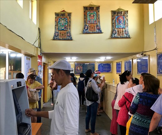 Getting money to pay for prayers at Ganden Monastery
