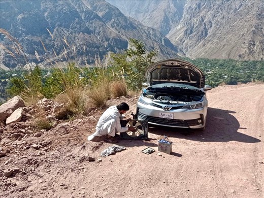Iqbal trying to fix the car