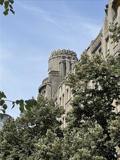 Figures on spire of commercial building at the end of Wenceslas Square