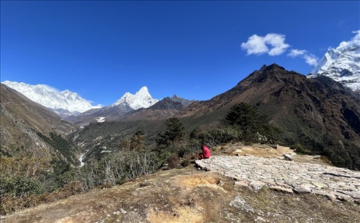 Monk on cell phone behind monastery