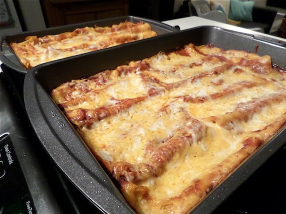 A pan of enchiladas after being cooked.