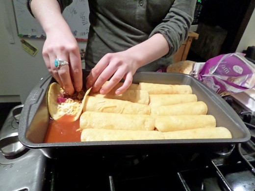 Filling enchiladas with cheese, chiles, chipotle peppers, onion, and love.