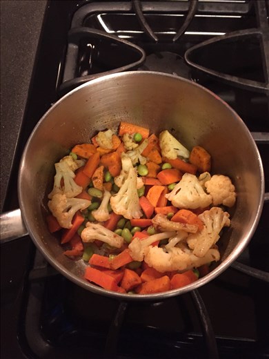 Vegtables coated with sizzling spices, step two in making vegtable curry.