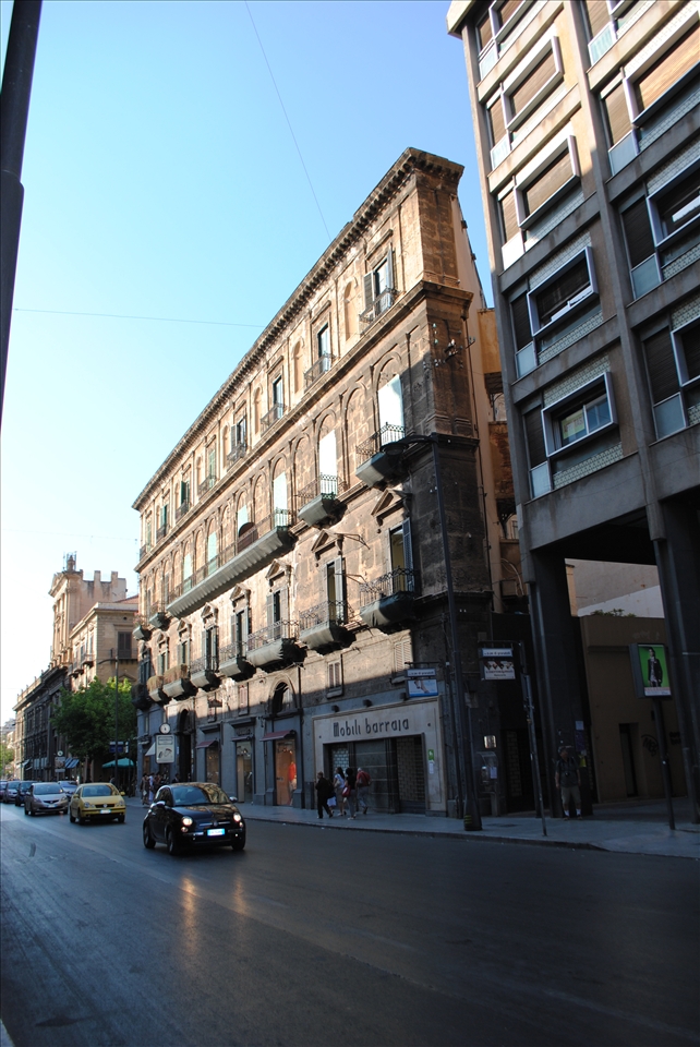 italian car before this strange house, tells about talent of italian people